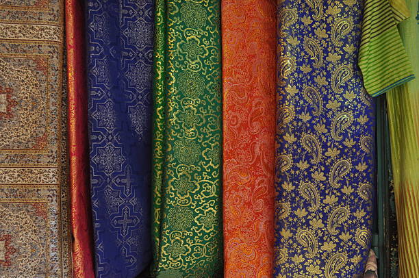 istock Colorful silk fabrics displayed in a market stall showcasing traditional patterns and designs from the region 2248524134