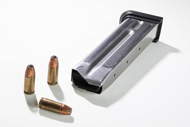 istock 9 mm hollow point bullets next to a magazine 2248526164
