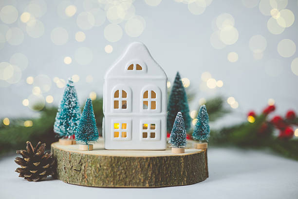istock Cozy white house nestled among small pine trees with festive lights blurred background 2248526284