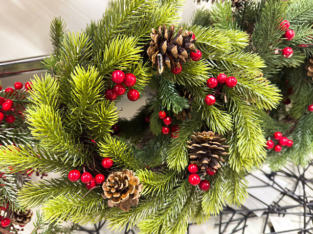 istock Festive holiday wreath with pinecones and red berries 2248528088