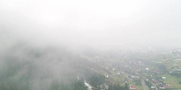 istock Thick fog in mountain, transparent clouds move under village 2248529039