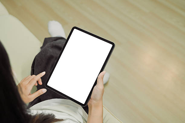 istock Close up view of a woman using blank screen digital tablet on sofa 2248529705