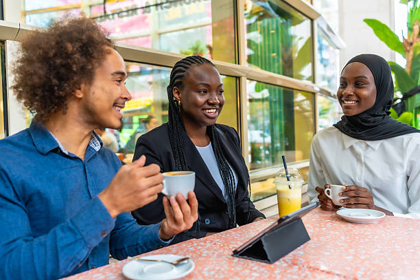 istock Diverse young adults having coffee and conversation at cafe 2248529912