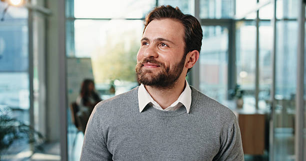istock Thinking, smile and business man in office for planning, reflection and brainstorming. Happy, insight and problem solving solution with male person in agency for perspective, vision and memory 2248530332