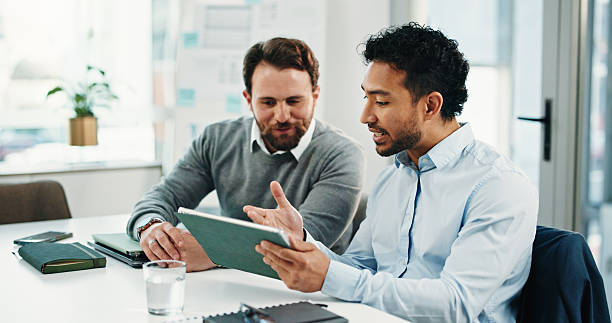 istock Tablet, team and business men with discussion, insurance proposal or conversation in office. Technology, planning and meeting for idea, risk management and problem solving for policy coverage 2248530453