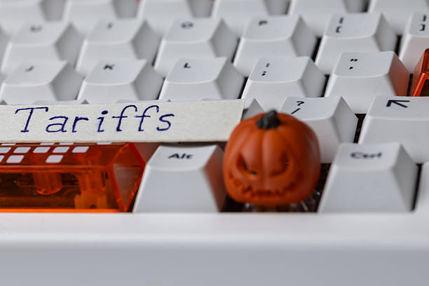 istock Tariffs concept on a mechanical keyboard with a small, spooky Halloween pumpkin, symbolizing global trade tensions, economic policy, and digital commerce 2248534839