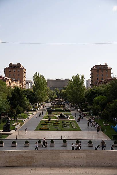 istock Urban viewpoint overlooking long city park with lawns and trees vertical 2248535250