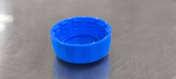 istock A blue soda bottle cap sits on a stainless steel table. 2248535696