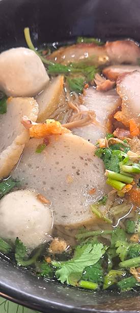 istock Noodle soup in a ceramic bowl on a wooden table 2248536360
