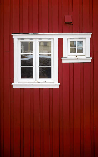 istock Traditional Falu Red wooden wall texture with white framed windows 2248536697