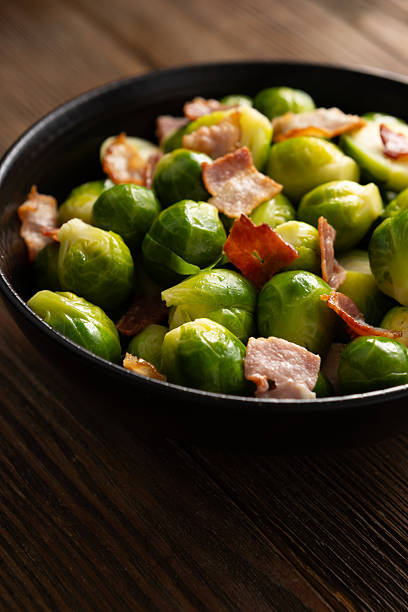 Close up of Baked brussels sprouts in bowl  rustic surface