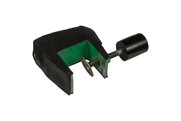 Rubber-padded table edge screw clamp with metal threaded knob is isolated.