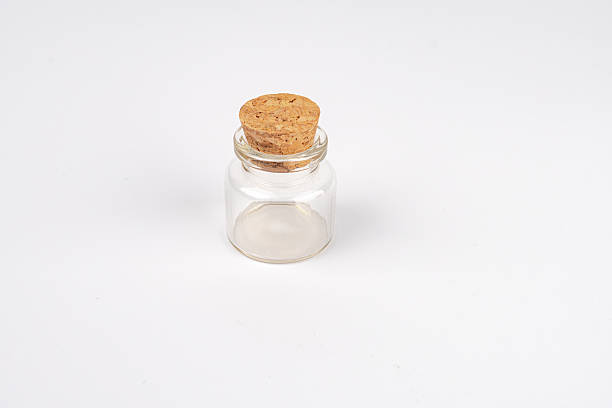 istock Empty test tube for potions, minimalist composition, single object central placement, glass jar with widened mouth, small item inside, stark background, no distractions, even lighting, artificial lig 2248539292