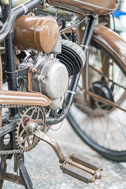 istock Vintage motorcycle, side profile view Brown engine with metal components, large circular headlight, two small lights, brown fender, cushioned seat, vintage design elements, neutral lighting, ambient 2248541760