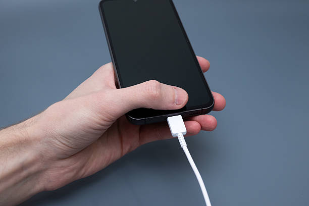 istock Charging smartphone with cable in hand close-up for digital technology concept 2248542816