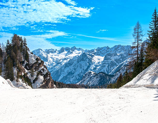Snowcovered ski slope in Cortina d'Ampezzo, Dolomites, Italy. Alpine winter scenery highlights sports, travel, and mountain tourism themes for versatile stock photography.