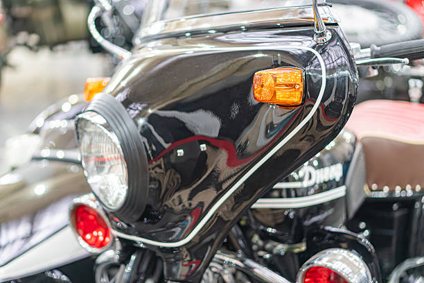 istock Vintage black motorcycle with chrome accents, showroom or exhibition setting, diffused artificial light, grey backdrop, diagonally arranged motorcycles, logo hints, high-end design 2248545351