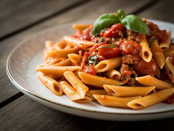 istock Penne pasta with tomato sauce and basil. 2248545549