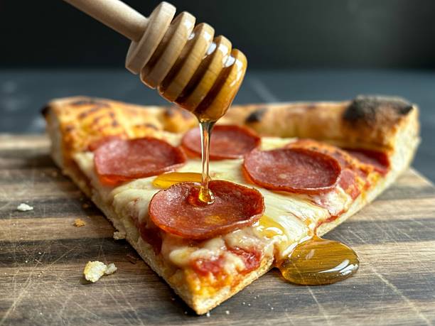 istock Pepperoni pizza slice with honey drizzle 2248545631