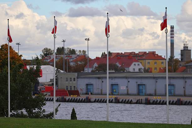 istock Polish Flags Waving by a Waterfront Industrial Port 2248545892