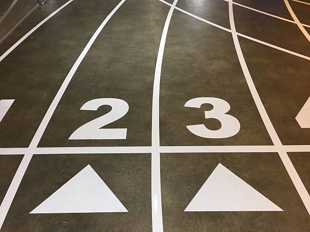Two Runners Sprinting on the Track During a Competitive Athletics Event