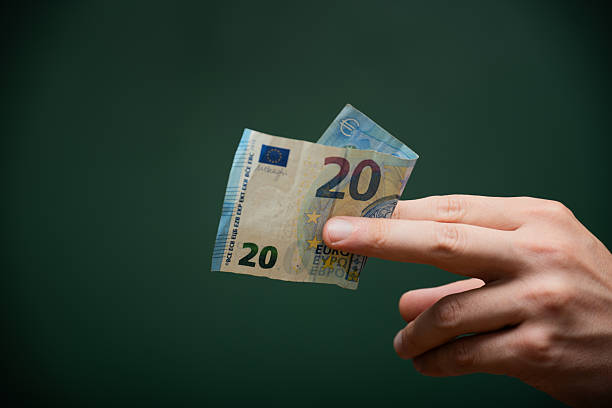 istock Hand holding twenty euro banknote cash payment 2248548068