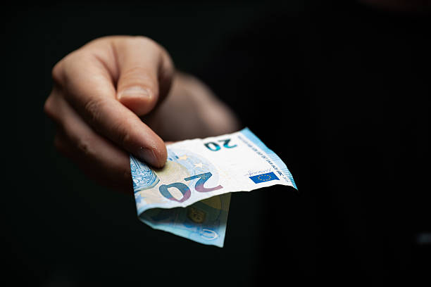 istock Hand giving twenty euro banknote for a transaction 2248548082
