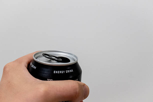 istock Hand Holding Open Black Energy Drink Can 2248548108