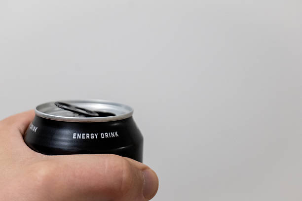 Hand opening a chilled metal energy drink can