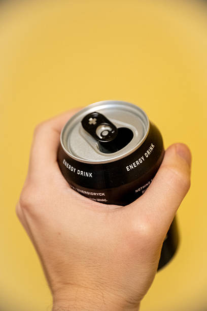 istock Hand Holding an Opened Black Energy Drink Can 2248548130
