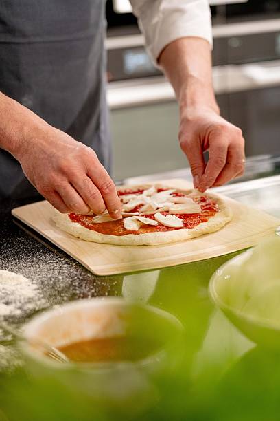 chef demonstrating the various steps for preparing pizza