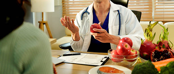 istock Dietician, male nutrition specialist consulting woman, developing healthy diet, dietary program. Dietary consultant asking, giving male patient advice, help, nutritional information, new meal plan 2248552863