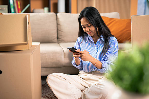istock Young asian woman using smartphone after moving home 2248559202
