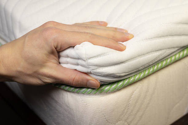 istock Hand is touching very soft orthopedic topper mattress. 2248560959