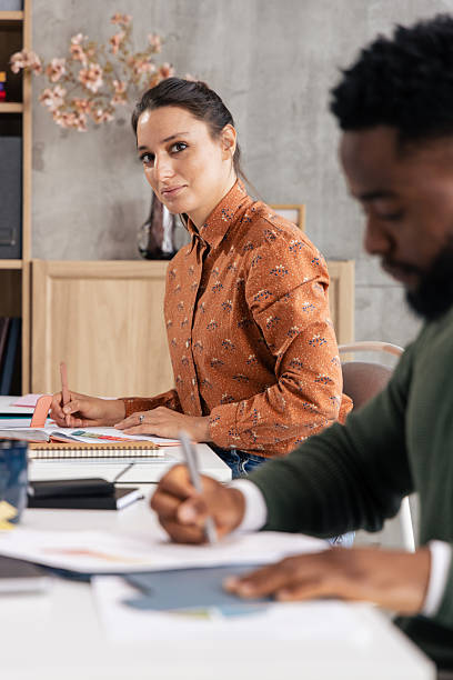 istock Diverse business professionals collaborating and working at office desk 2248562526