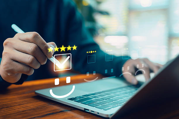 istock Business person rating a five-star digital satisfaction form using a stylus on a laptop, symbolizing customer feedback, review evaluation, user experience, service quality, and modern digital survey 2248563499