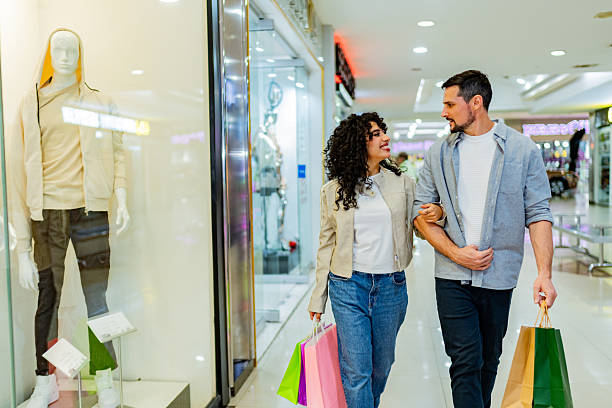 istock Couple walking through shopping mall 2248564858