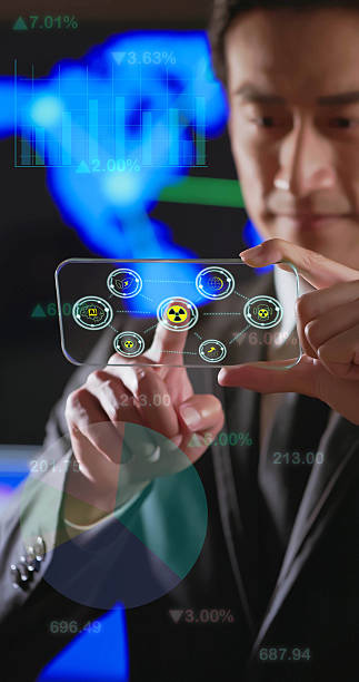 istock Businessman using transparent smartphone with nuclear energy hologram concept 2248565551