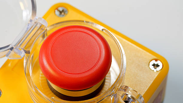 istock Red emergency stop push button with clear protective cover open enclosure, industrial mushroom switch on machinery control panel, safety shutdown device close up detail, emergency abstract concept 2248565898