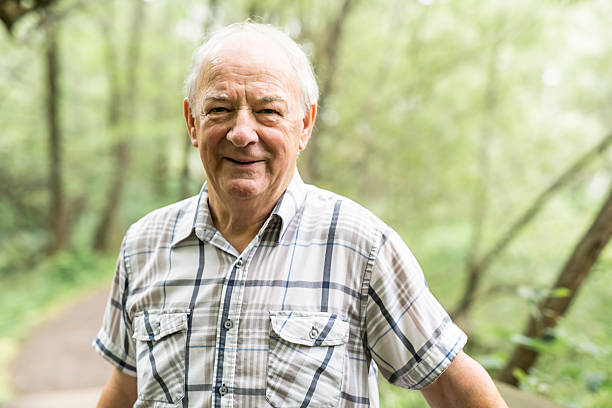 istock Senior man in the nice forest park 2248566006