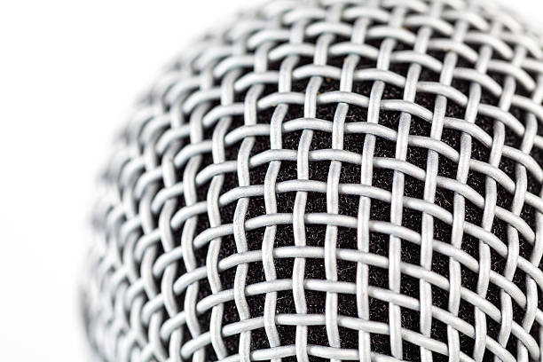 istock Macro closeup detail of a silver microphone grille structure with woven metal mesh, abstract background texture for studio audio recording and podcast studio themes, voice music production backdrop 2248566079