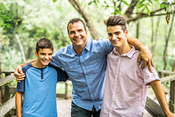 istock Father having fun in forest with his two sons 2248566088