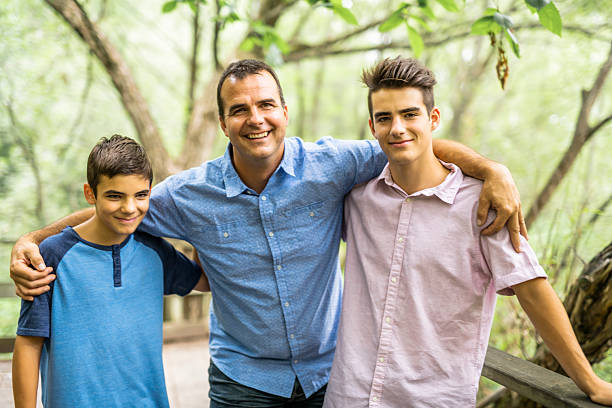 istock Father having fun in forest with his two sons 2248566094
