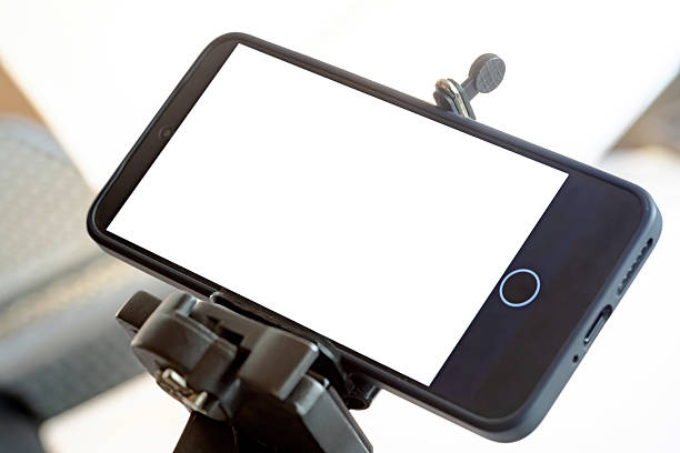 istock A smartphone mounted on a tripod, home studio, blank white empty cut out screen recording a product review on a table horizontal mobile phone mockup streaming content creation influencer video concept 2248566483