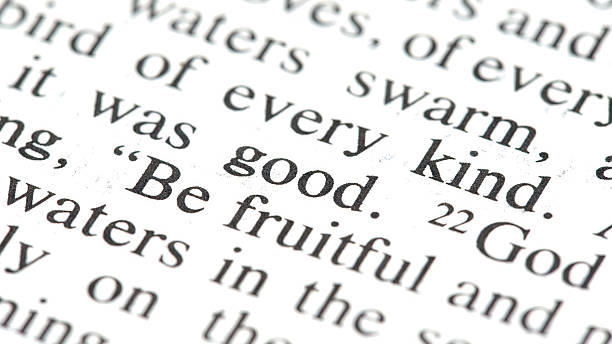 Bible text macro with the words be fruitful  good in focus, scripture verse detail from Genesis on printed page, religion faith concept background, selective focus typography close up, no people