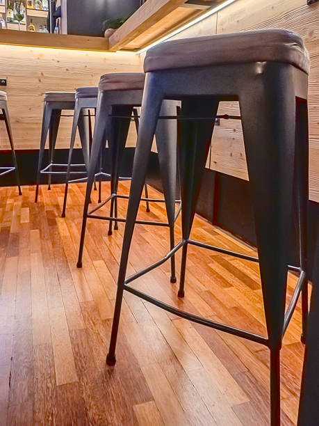 istock Modern bar interior with high metal stools and wooden floor 2248567646