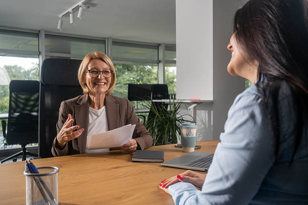 istock Happy insurance agent with her customers in the office. 2248571800