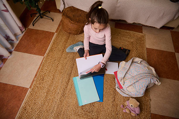 istock Young Girl Studying At Home With Notebooks, Backpack, And Cozy Rug 2248572409