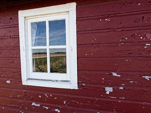 Window and land reflection on red barn at Carter historic farm. Carter historic farm land and buildings part of the Wood County Park District and Black Swamp nature conservancy open to the public.