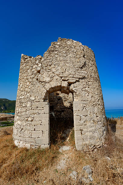 istock Old windmill at Agios Ioannis beach, Lefkada, Greece. Ruin of an old windmill. 2248578704
